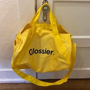 Glossier yellow duffel bag
